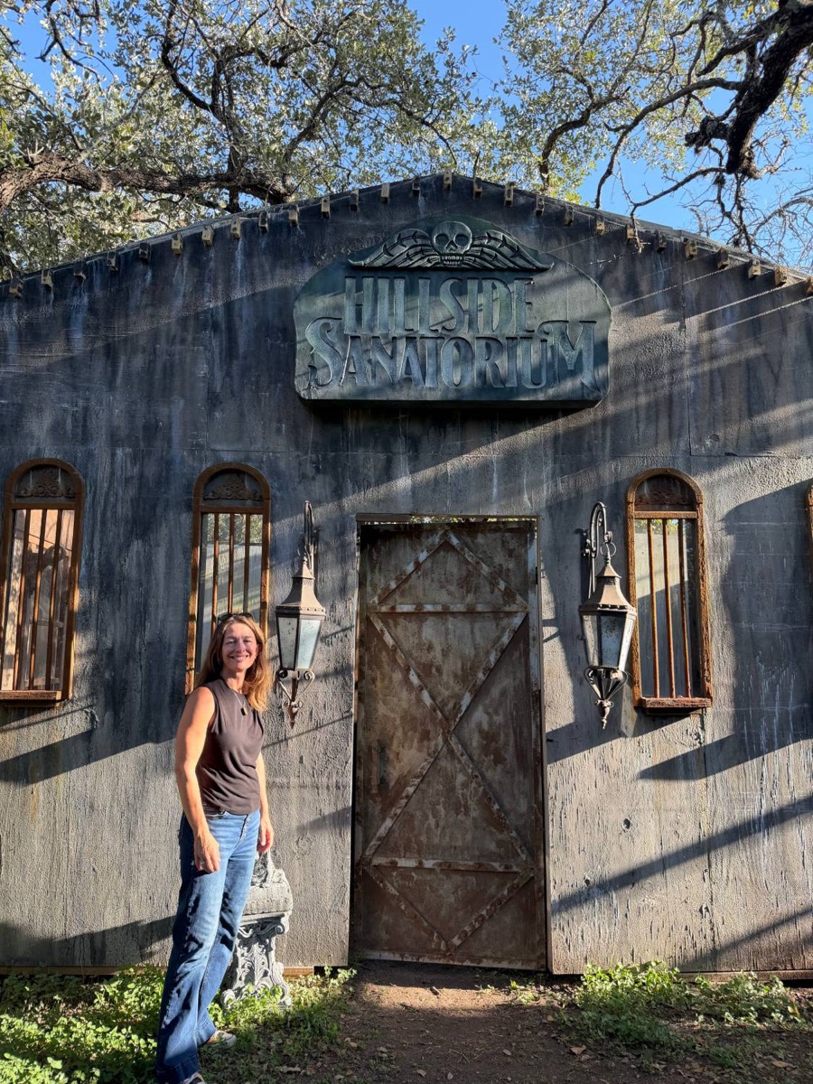 April Garner standing outside the Hillside Sanatorium building in the haunt
