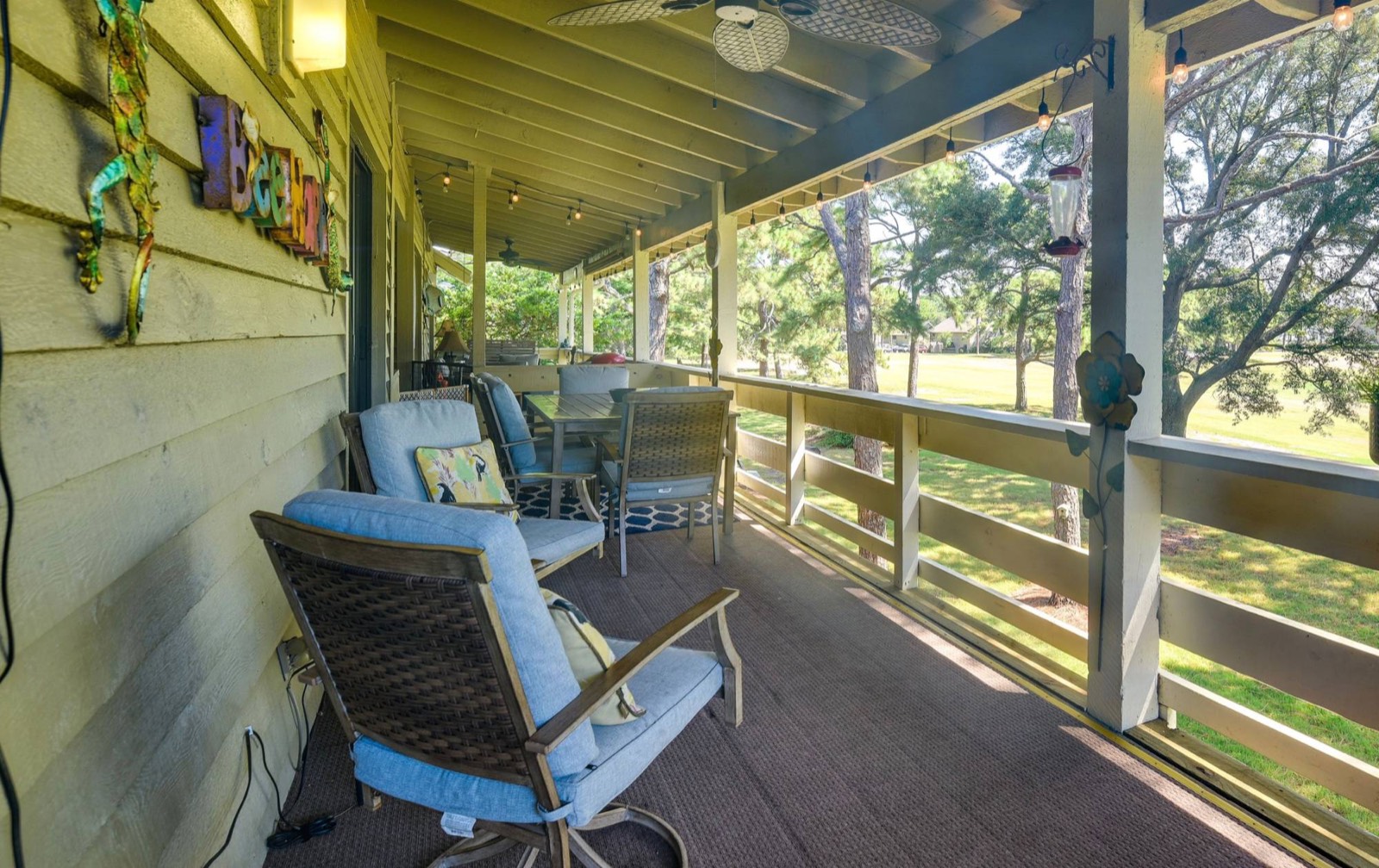 Long covered balcony with seating and dining table