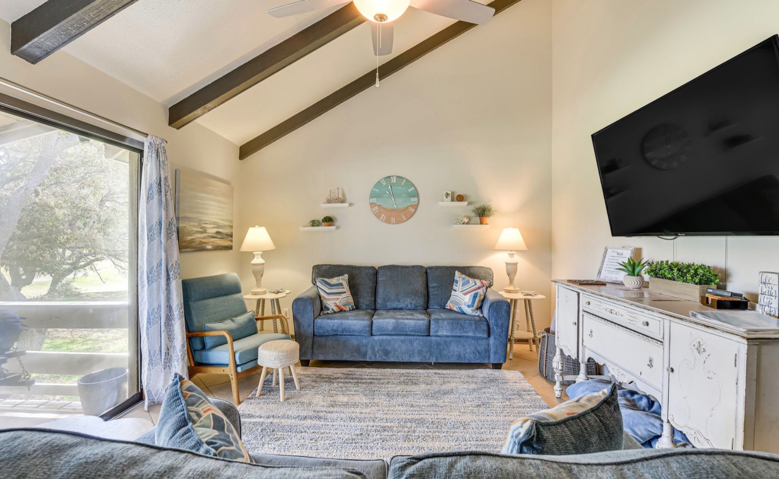 Living room with vaulted beamed ceiling and blue sofa