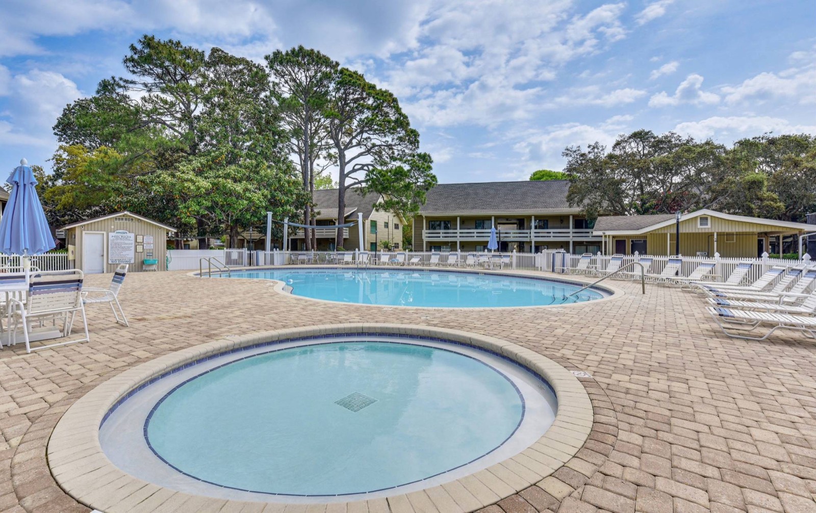 Community pool surrounded by pines