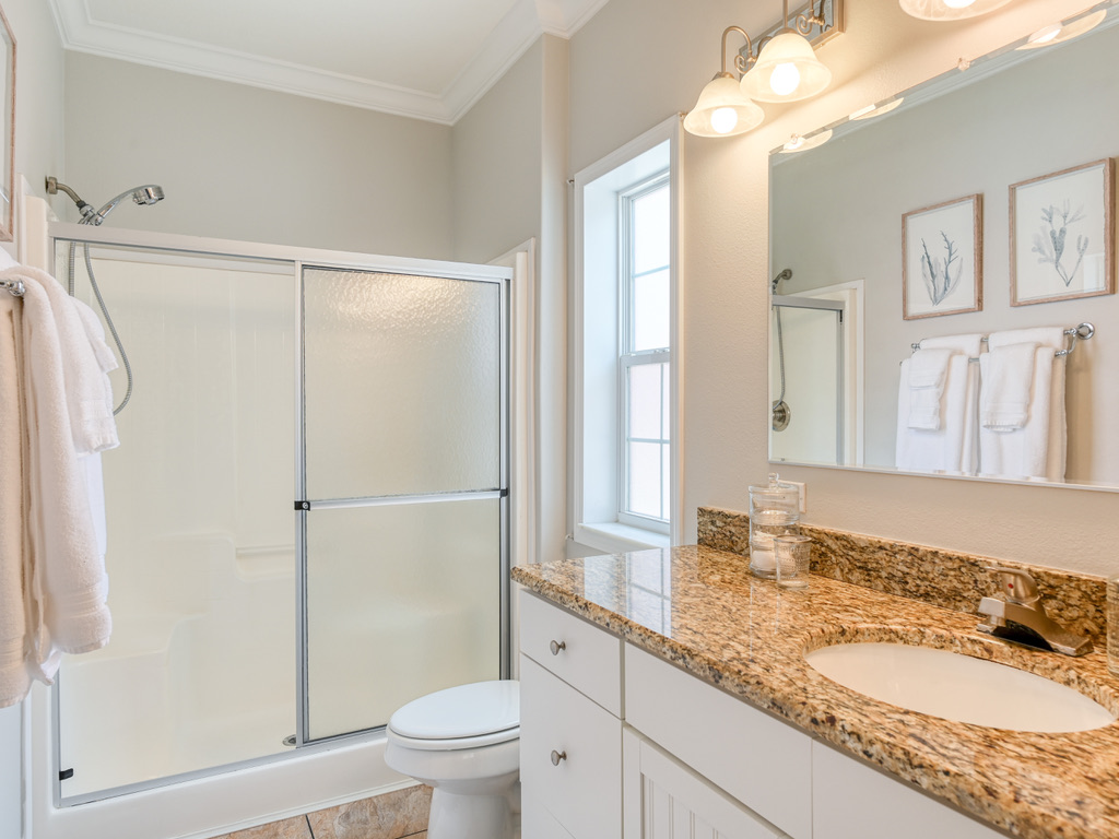 Bathroom with walk-in shower and granite vanity