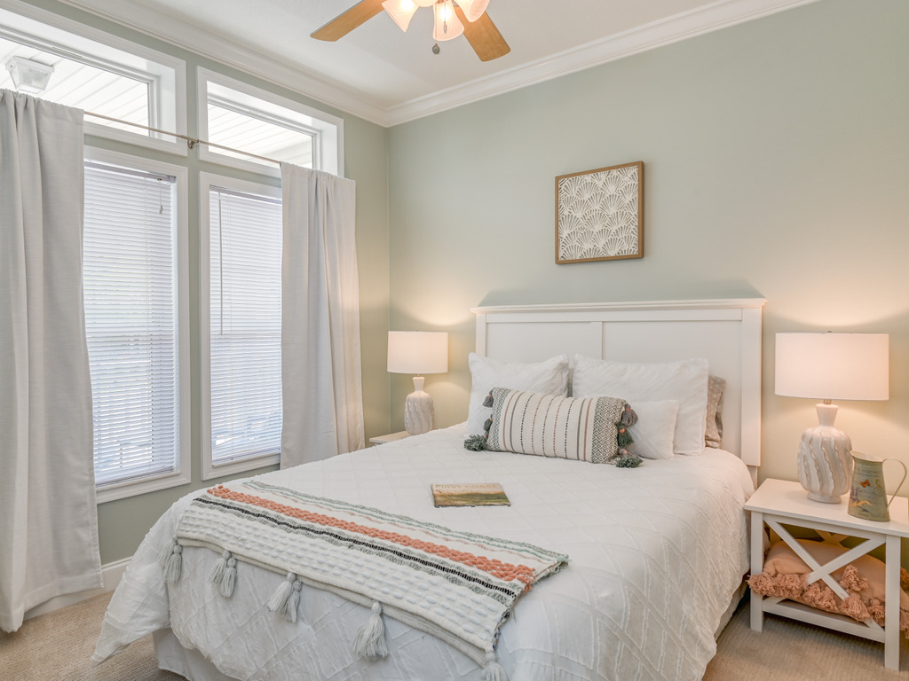 Sage green bedroom with tall windows