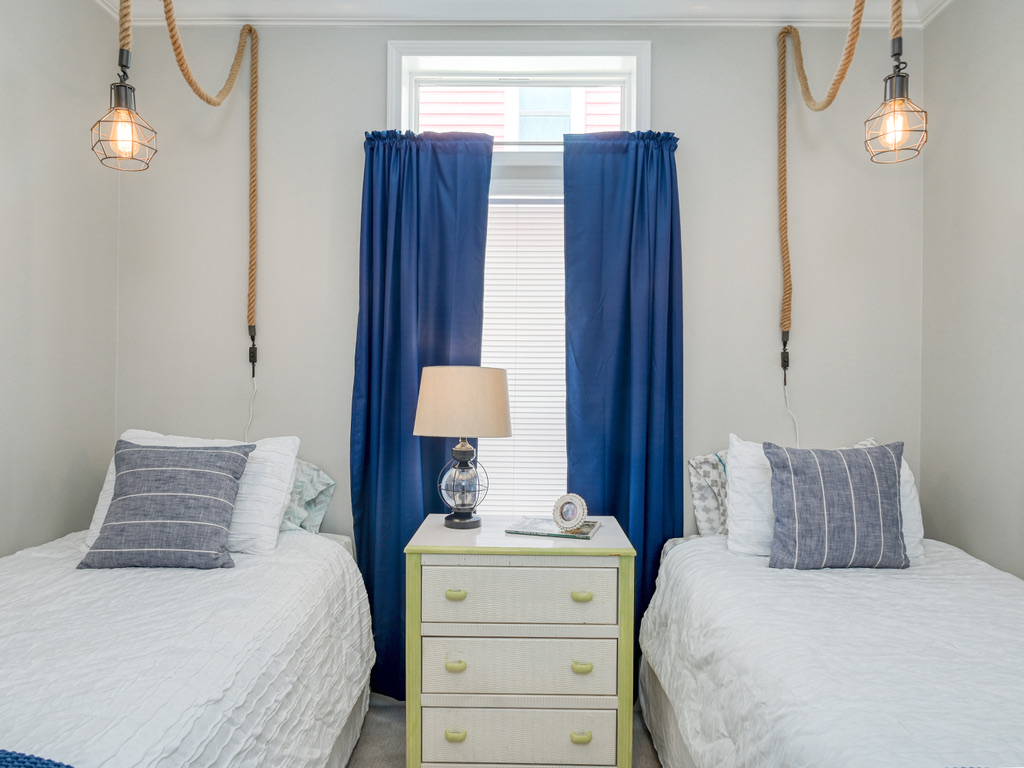 Twin bedroom with rope pendant lights